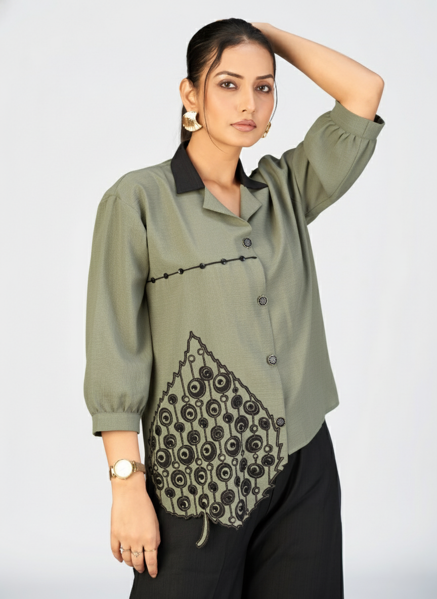 Beige embroidered top with contrast black collar showcased on a model.