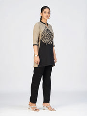 Stylish women’s kurti with three-quarter sleeves and decorative leaf appliqué design.