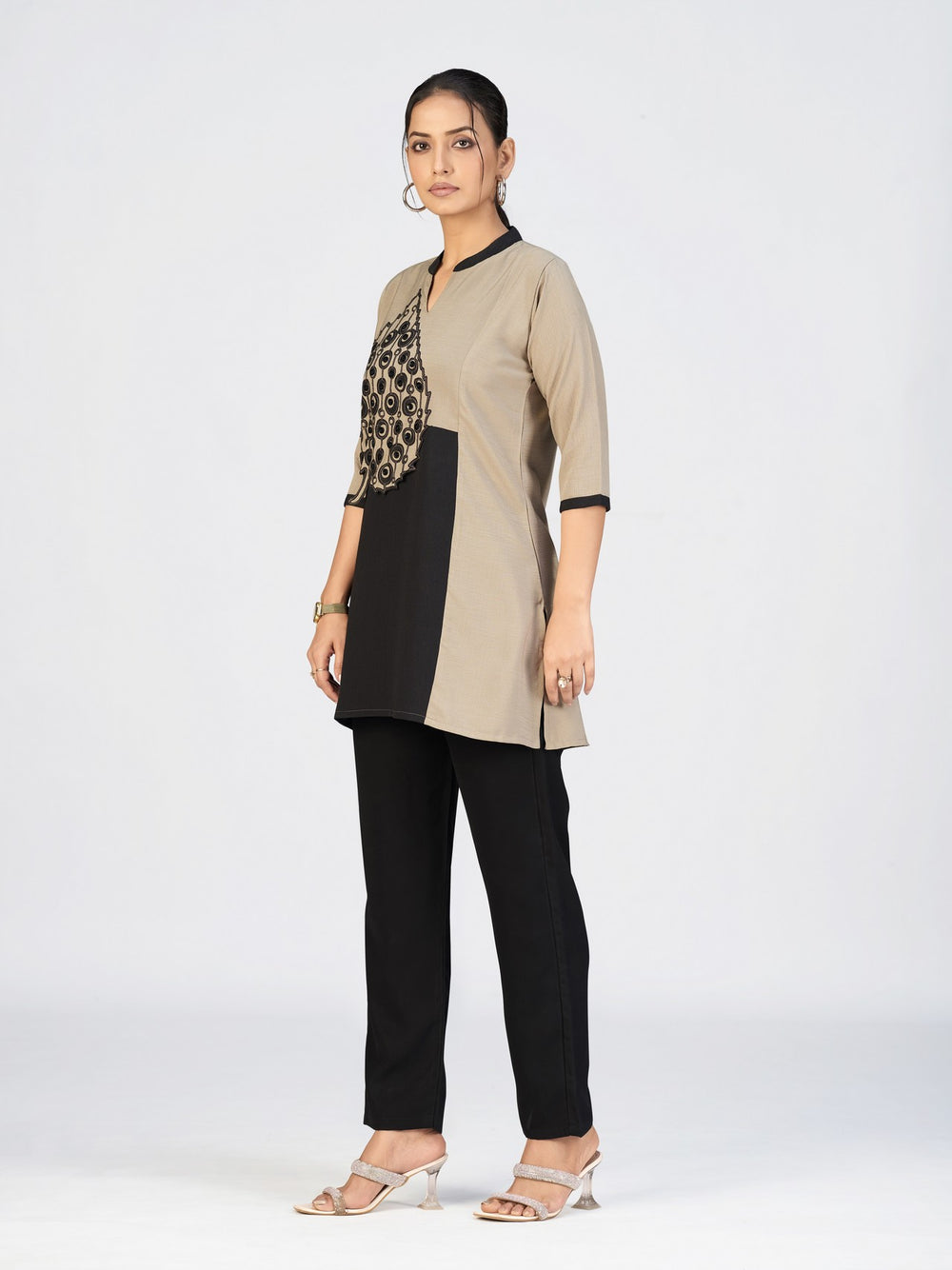 Model posing in a modern dual-tone kurti paired with black straight pants.