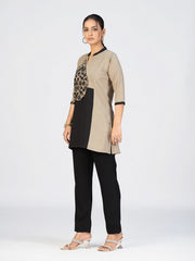 Model posing in a modern dual-tone kurti paired with black straight pants.