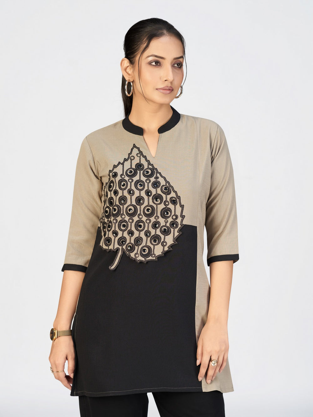 Fashion model wearing a unique appliqué kurti with contrast neckline and sleeves.