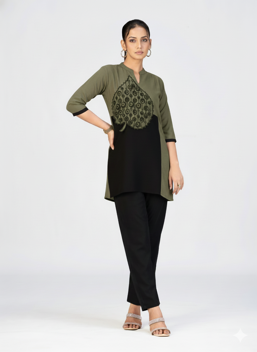 Full-length image of a woman in a stylish embroidered kurti paired with pants and heels.