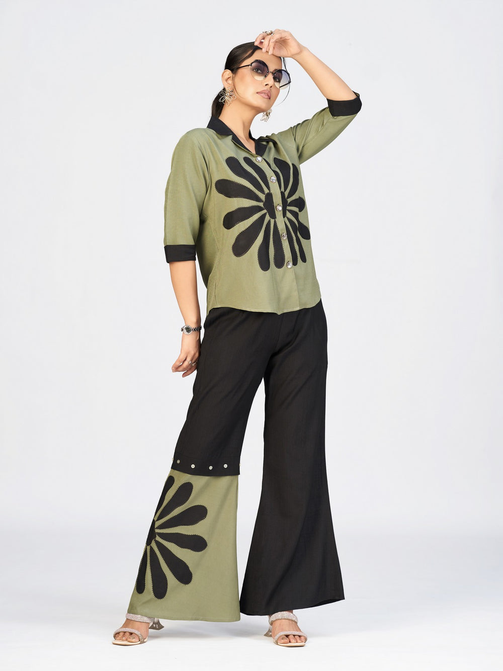 Stylish ethnic-fusion outfit in olive green and black worn by a model during a professional photoshoot.