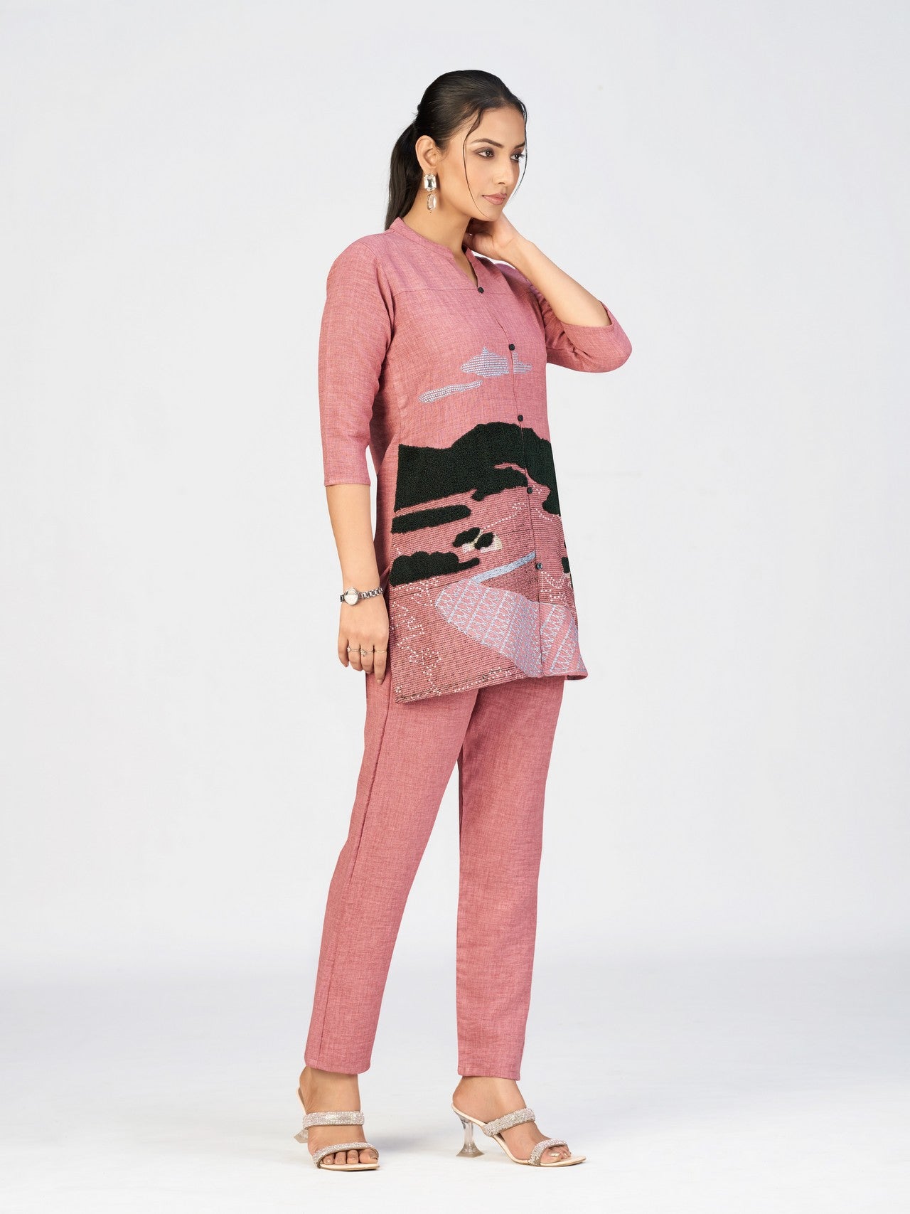 Front view of embroidered pink kurti with unique scenic design and three-quarter sleeves.