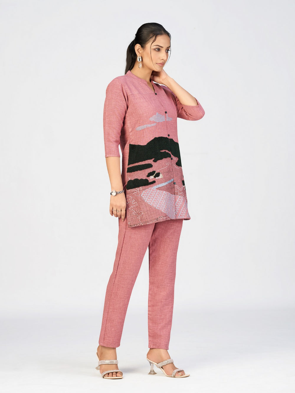 Front view of embroidered pink kurti with unique scenic design and three-quarter sleeves.
