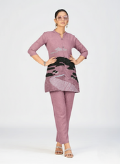 Female model wearing a designer pink embroidered kurti with button closure.
